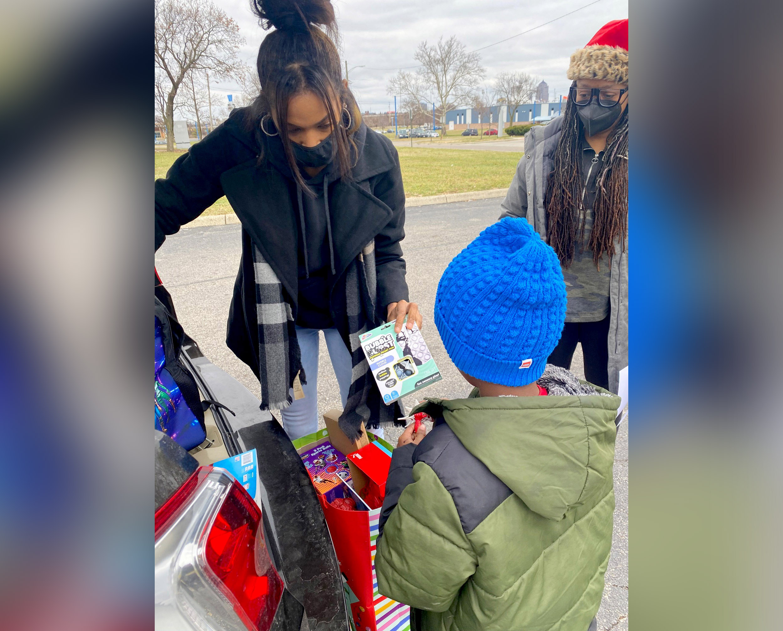 PHOTO: Janese Boston distributes a toy to a child during the "Build a Bond" toy drive she founded in Franklin County, Ohio.