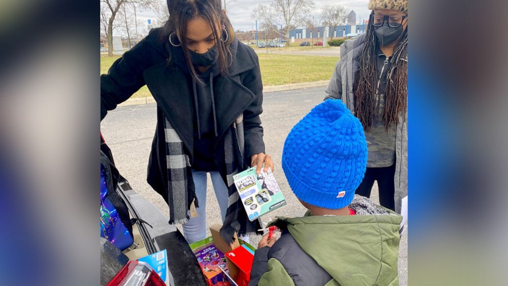 PHOTO: Janese Boston distributes a toy to a child during the "Build a Bond" toy drive she founded in Franklin County, Ohio.