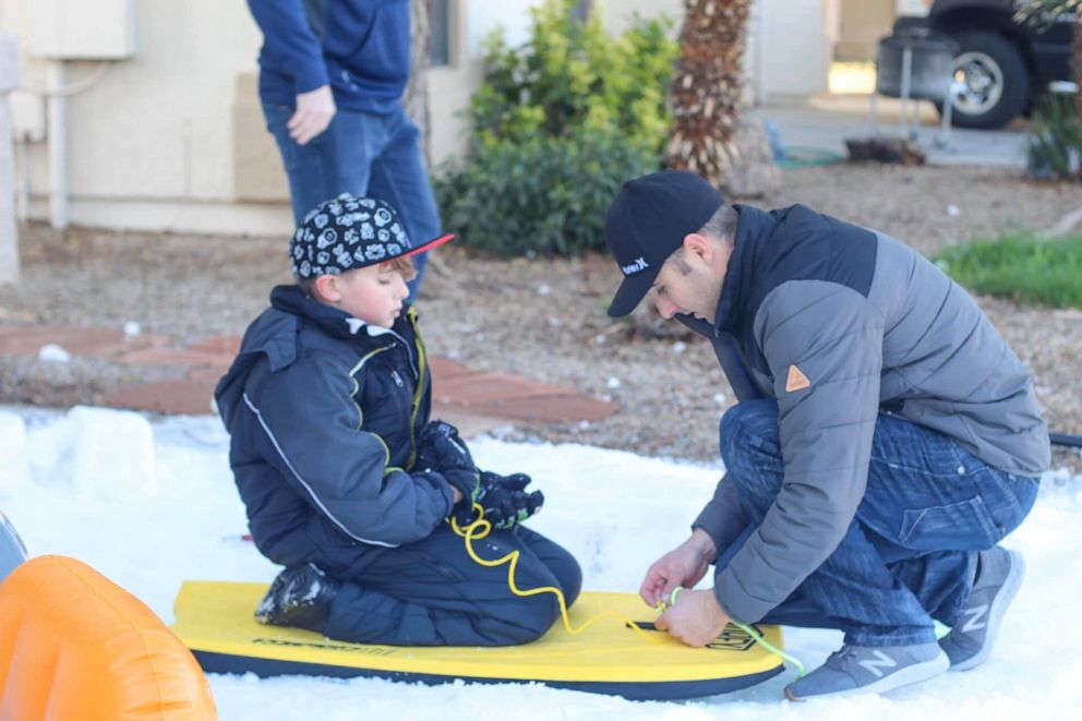 PHOTO: Along with the Casa Grande Police Department, the Casa Grande Fire Department created five tons of snow and laid it on the Walkers' property. Quinn Walker and her brothers made snow angels, a snowman, went sledding and had snowball fight.