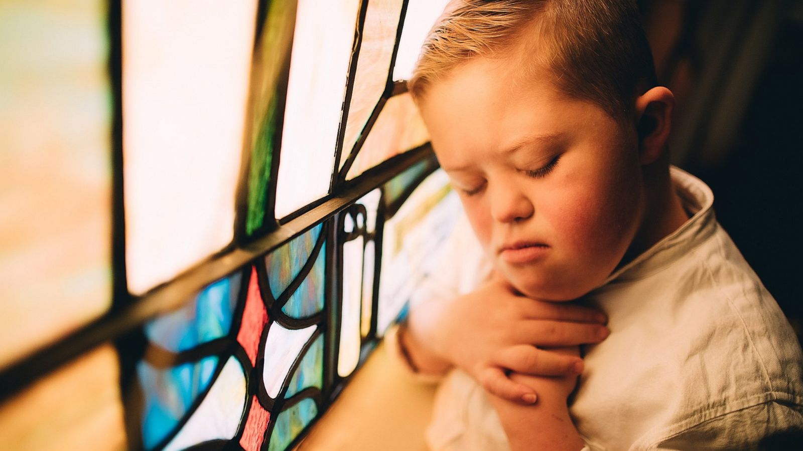 PHOTO: Grady Witkowski in front of a stained class window during a photo session his mom, a photographer, held on the occasion of his 10th birthday.