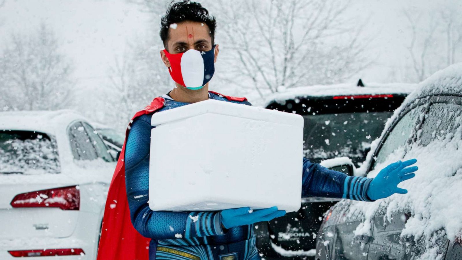 PHOTO: Dr. Mayank Amin vaccinates his community in a Superman suit.