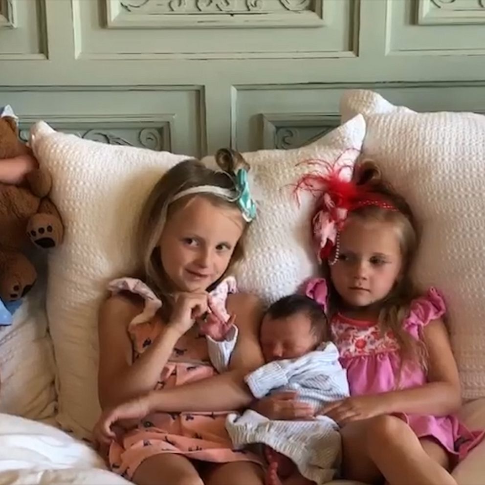 3 big sisters greet newborn brother from hospital window