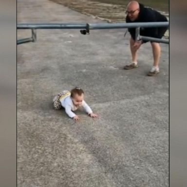 VIDEO: Baby’s adorable crawl under gate following dad’s lead