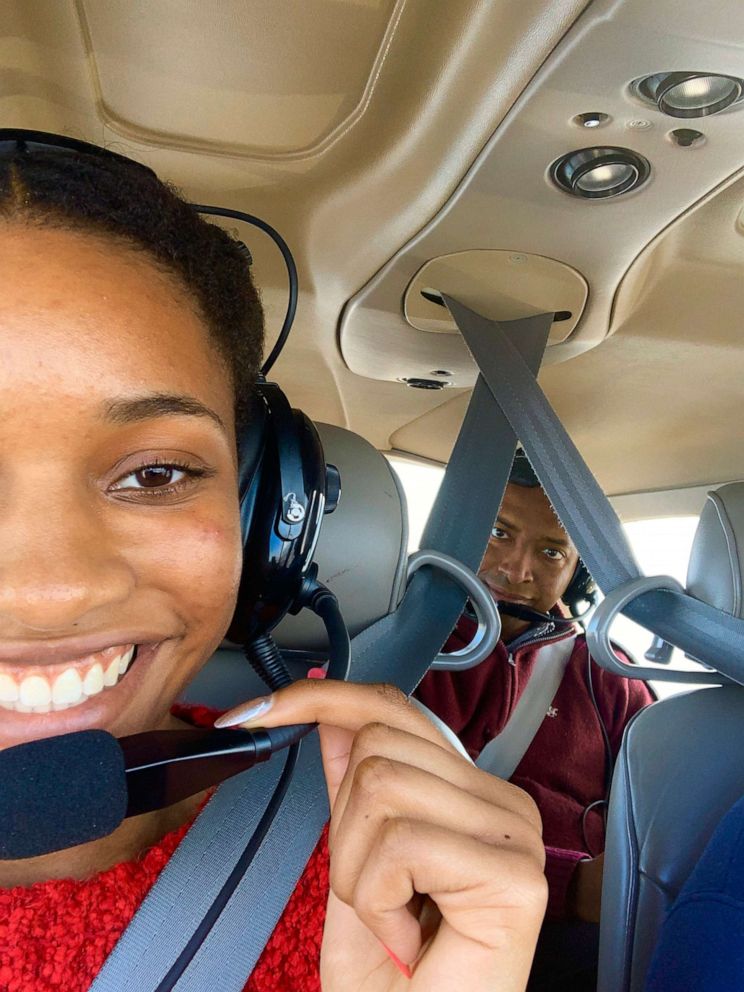 Nilah Williamson flying her mentor Admiral Arthur Johnson six years after he showed her the flight simulator that inspired her to want to become a pilot.