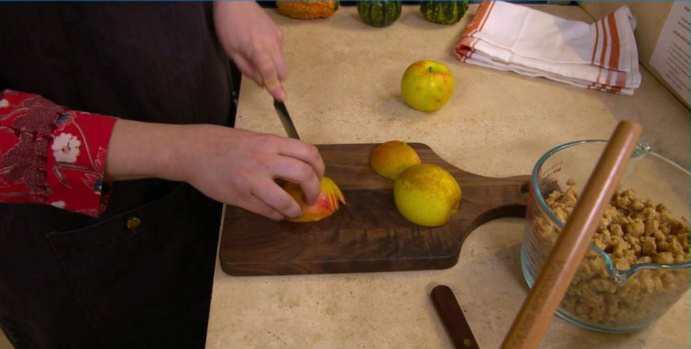 PHOTO: Claire Saffitz shows how to slice an apple using the tip of her knife so it doesn't stick while cutting.