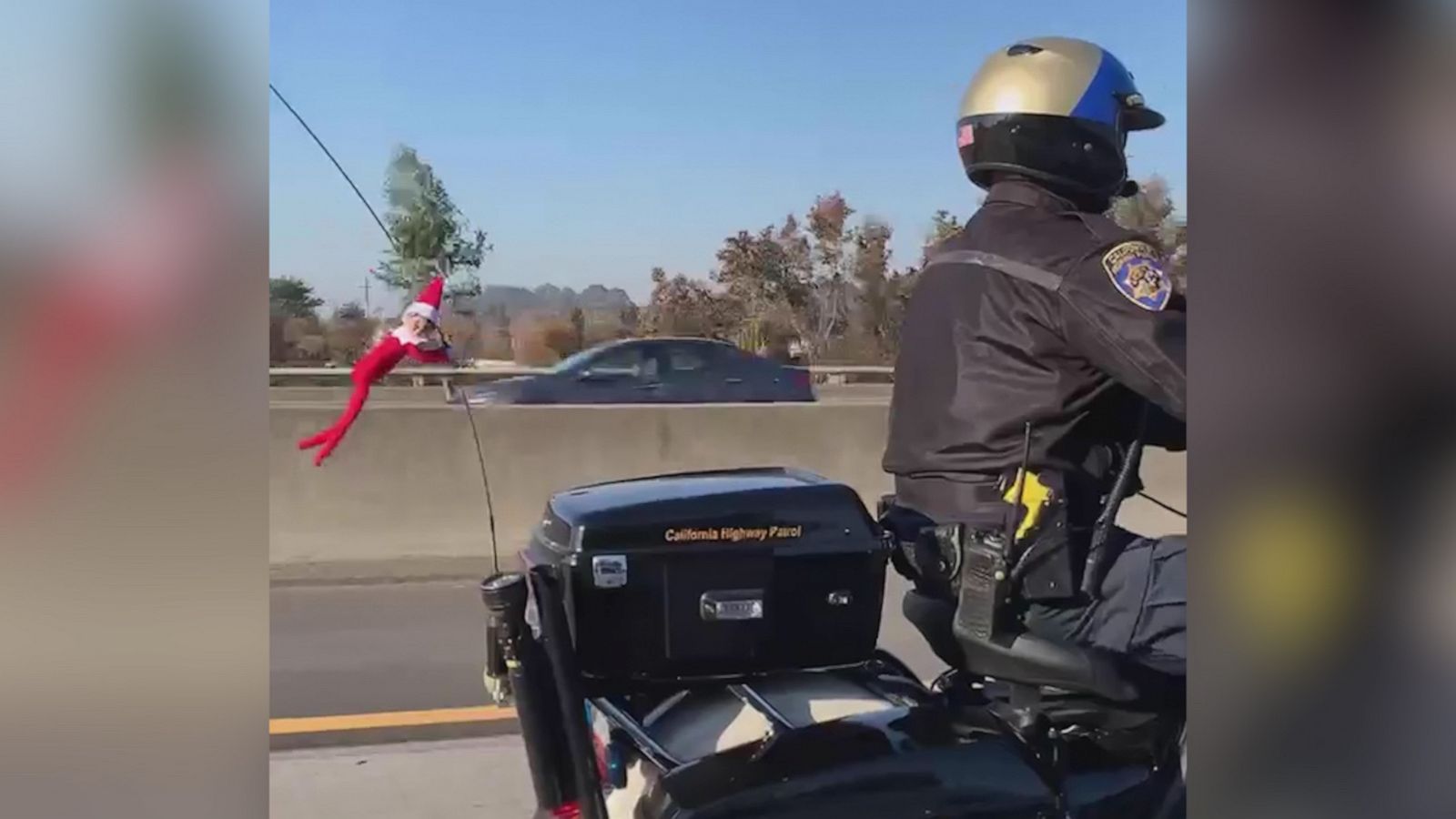 VIDEO: Elf hitches a ride on police officer's motorcycle