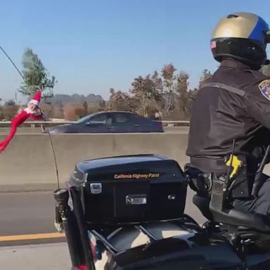 VIDEO: Elf hitches a ride on police officer's motorcycle