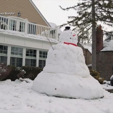 VIDEO: Dad and daughter build 10-foot snowman