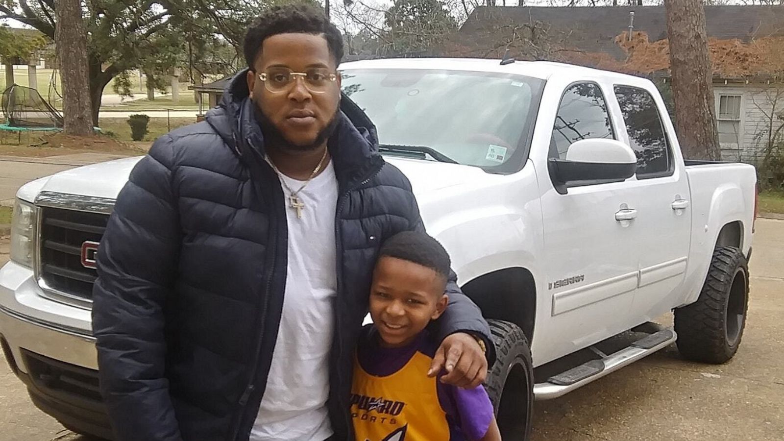 PHOTO: Devin Hinkston, 30, poses with 8-year-old Jeremiah after buying him a basketball hoop.