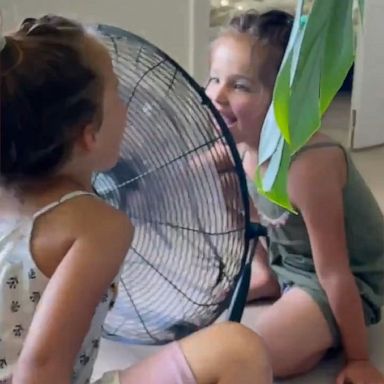 VIDEO: Sisters make cute 'robot noises' while keeping cool during the 115°F heatwave 