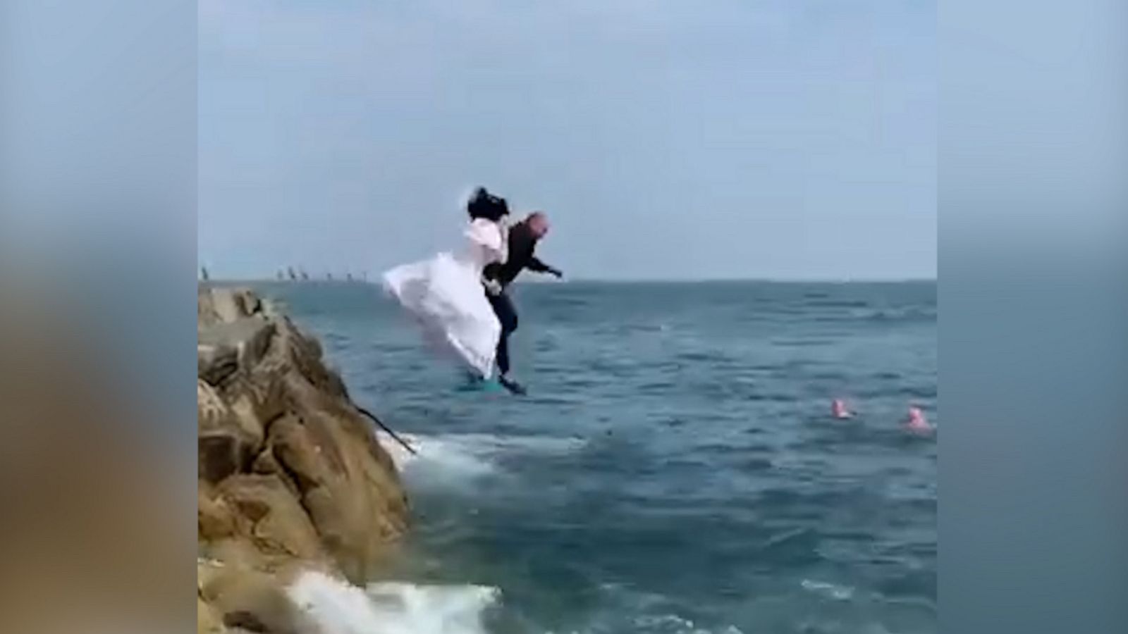 VIDEO: Bride and groom jump into the sea in full wedding attire