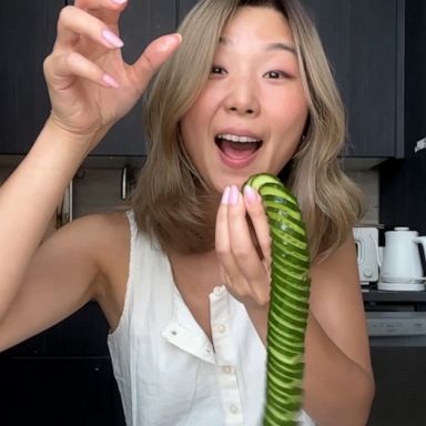 Female hand holding a cucumber with a spiral knife