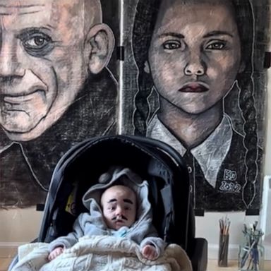 VIDEO: Baby poses in front of 'Addams Family' art exhibit 