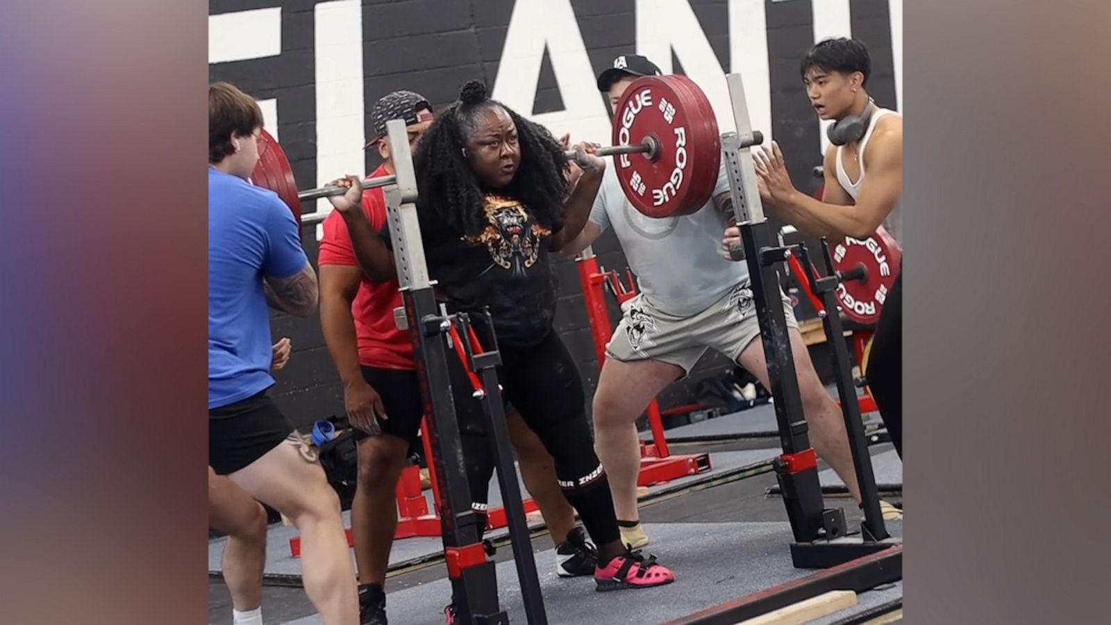 VIDEO OFFER: Woman crushes her squats and has the best hype squad