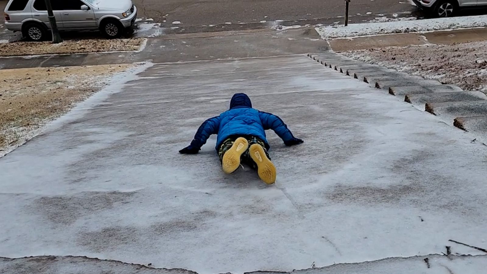 VIDEO: Mother-son duo enjoys sliding down icy driveway