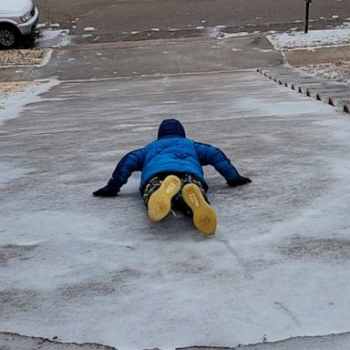 VIDEO: Mother-son duo enjoys sliding down icy driveway