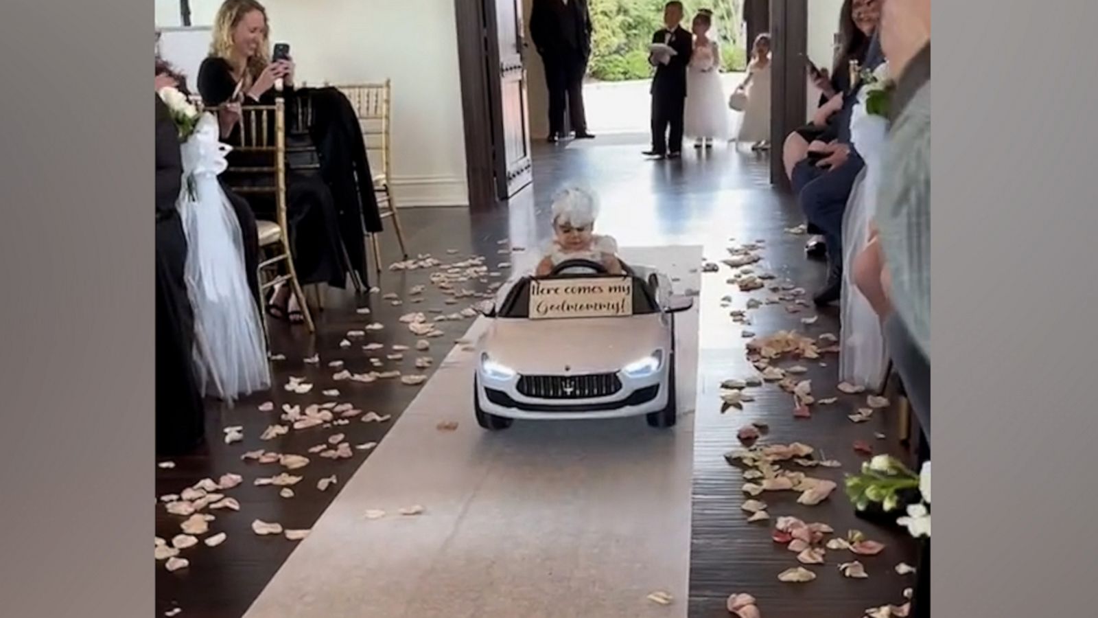 VIDEO: Flower girl has epic entrance for godmother's wedding ceremony