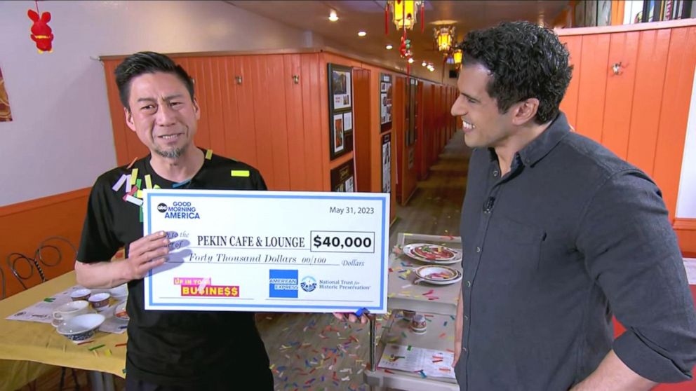 PHOTO: Jerry Tam holds up a $40,000 check from American Express.