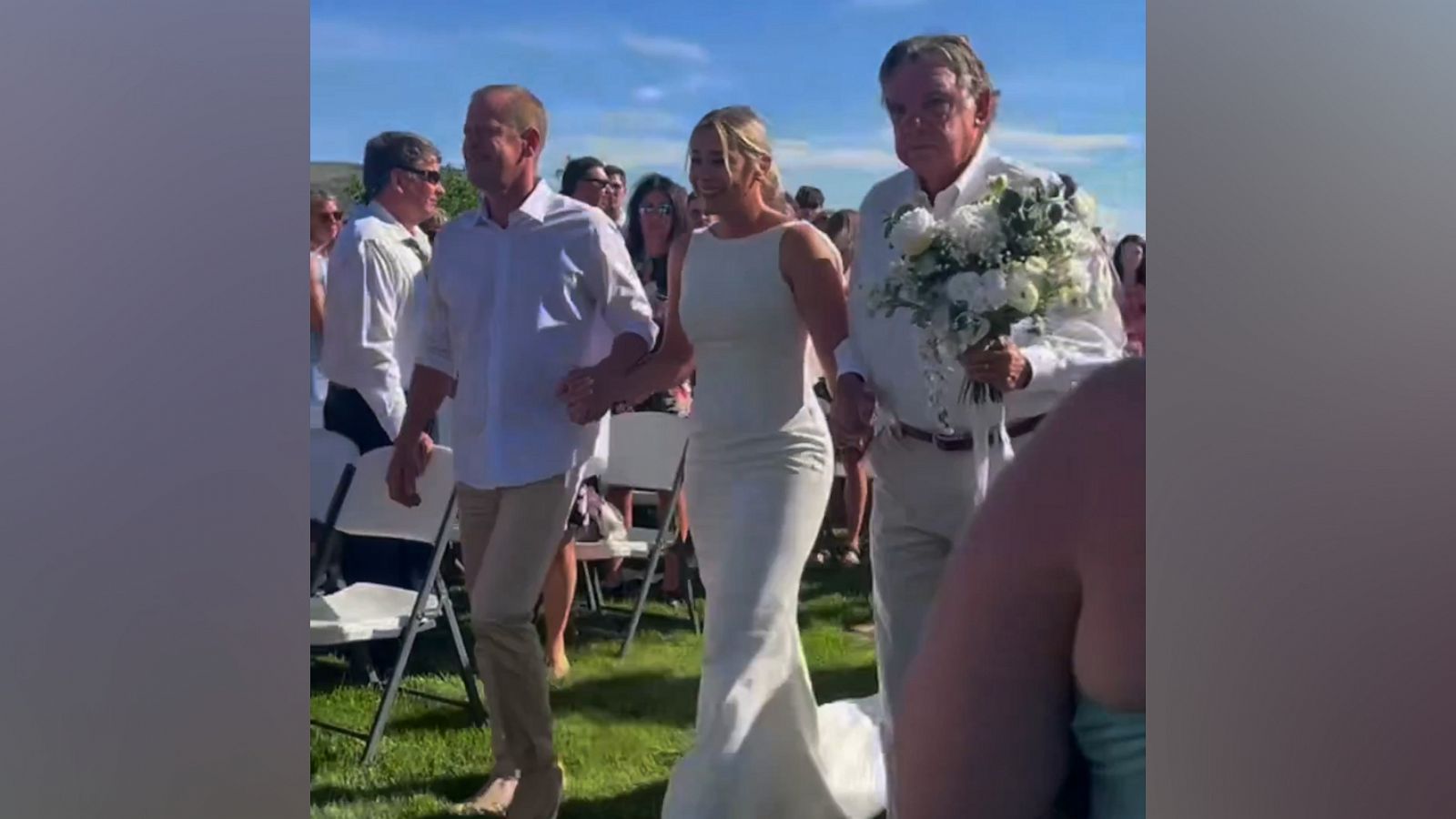 VIDEO: Bride walks down aisle with 15 important men in her life