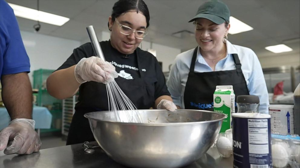 PHOTO: Unique Sweets owner Liza Pereira in the kitchen with one of their bakers.