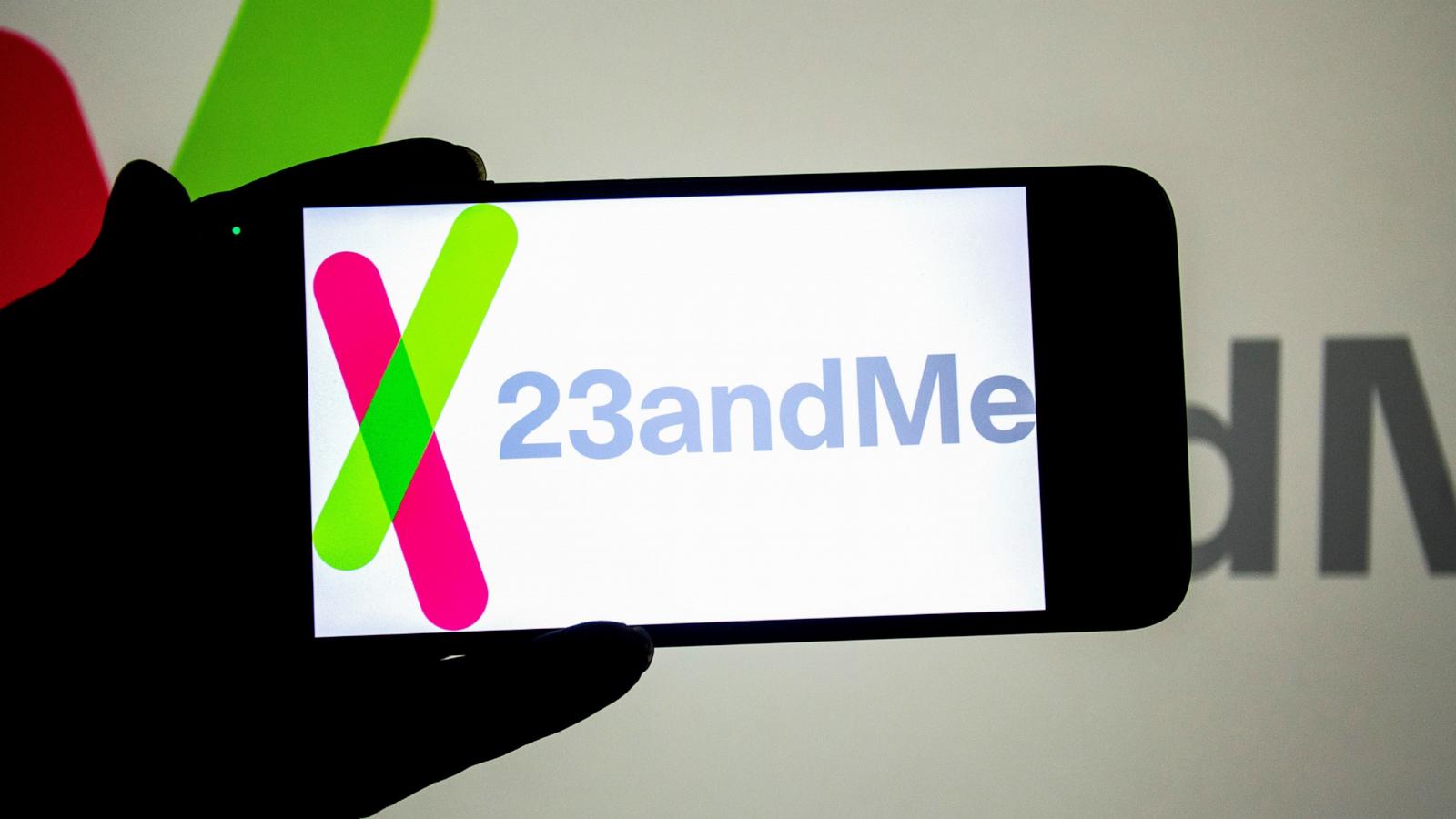 PHOTO: In this photo illustration, a 23andMe logo seen displayed on a smartphone and in the background.