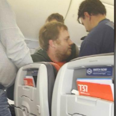 VIDEO: Unruly passenger tries to open plane door mid-flight