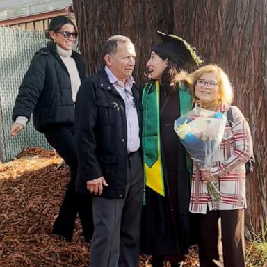 VIDEO: Woman walks into family photo to surprise sister at graduation 