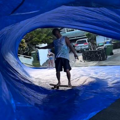 VIDEO: Surfer dad rides skateboard under a tarp like it's a wave 