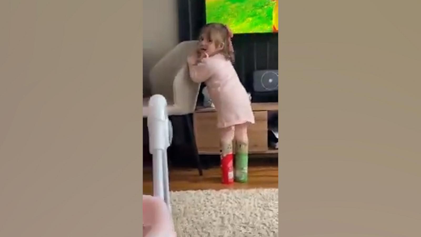 VIDEO: Toddler experiments with fashion, wears Pringles cans as shoes