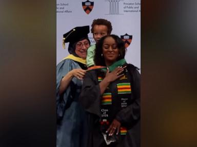 WATCH:  Adorable 3-year-old helps mom with master’s hood at graduation ceremony