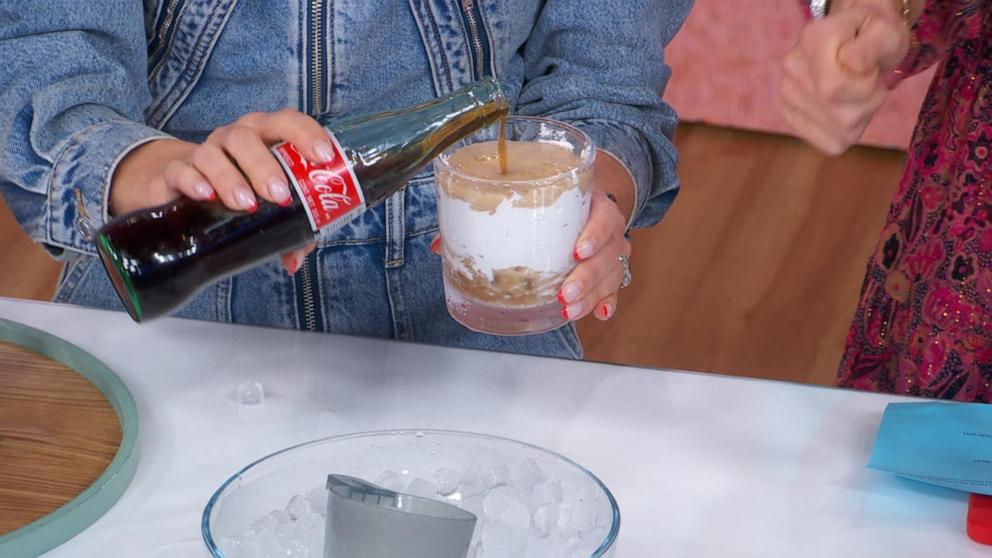 PHOTO: Pouring Coca-Cola into a marshmallow fluff-lines glass to make Fluffy Coket as seen on TikTok.