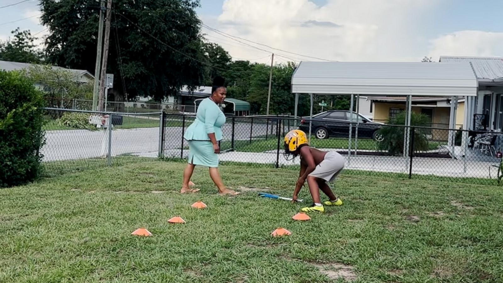 Dedicated mom trains football with her son