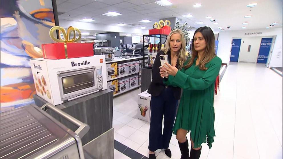 PHOTO: Becky Worley with Lilian Rincon, VP of Product for Google Shopping, use Google Lens to get product information on a Breville Smart Oven.