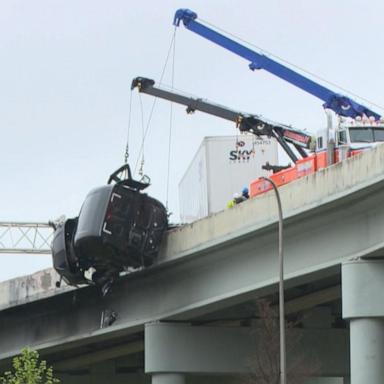 VIDEO: Truck driver rescued dangling off overpass