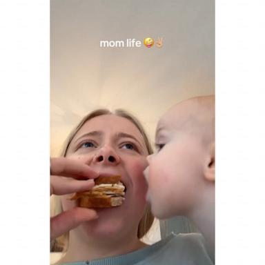 Toddler eating food out of mom's mouth sums up parenthood