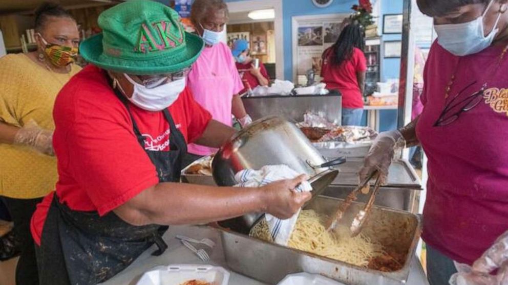 PHOTO: Sylvia Tisdale helps prepare plates of food for people in Pensacola, Florida.