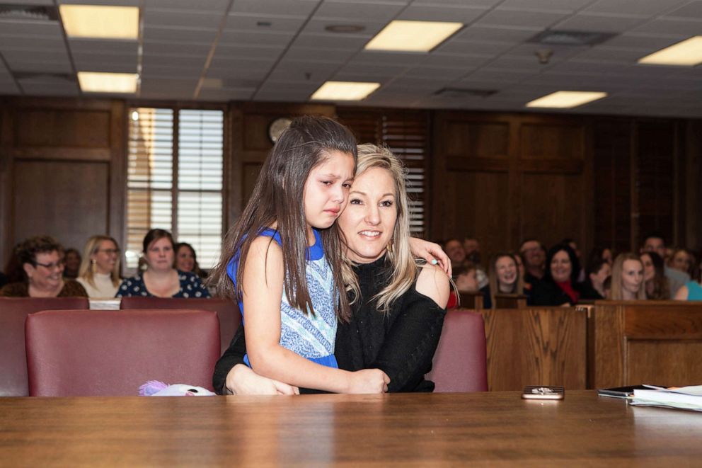 PHOTO: Selah Scott, 8, is seen with her mother, Suzanne Scott in Lubbock, Texas, on March 5 as she was adopted among family and friends
