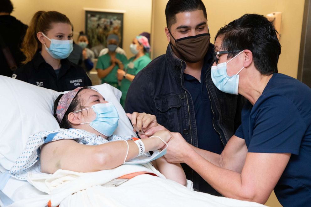 PHOTO: Serena Torres is greeted by Westchester Medical Center workforce members as she departs the hospital after being treated for COVID-19.