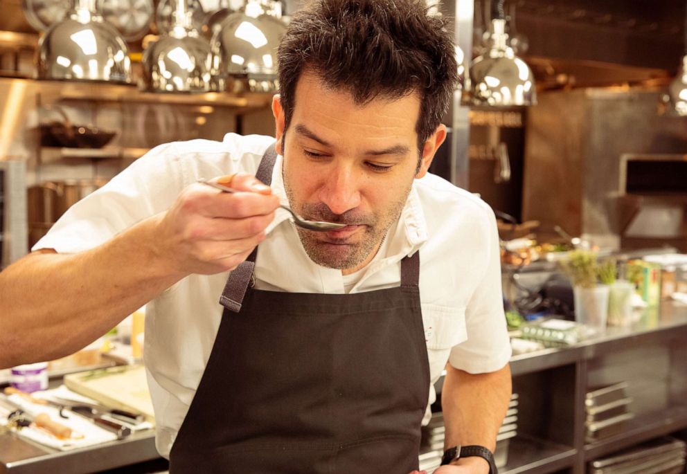 PHOTO: Chef George Mendes tastes while cooking at his Michelin-starred restaurant Aldea. 