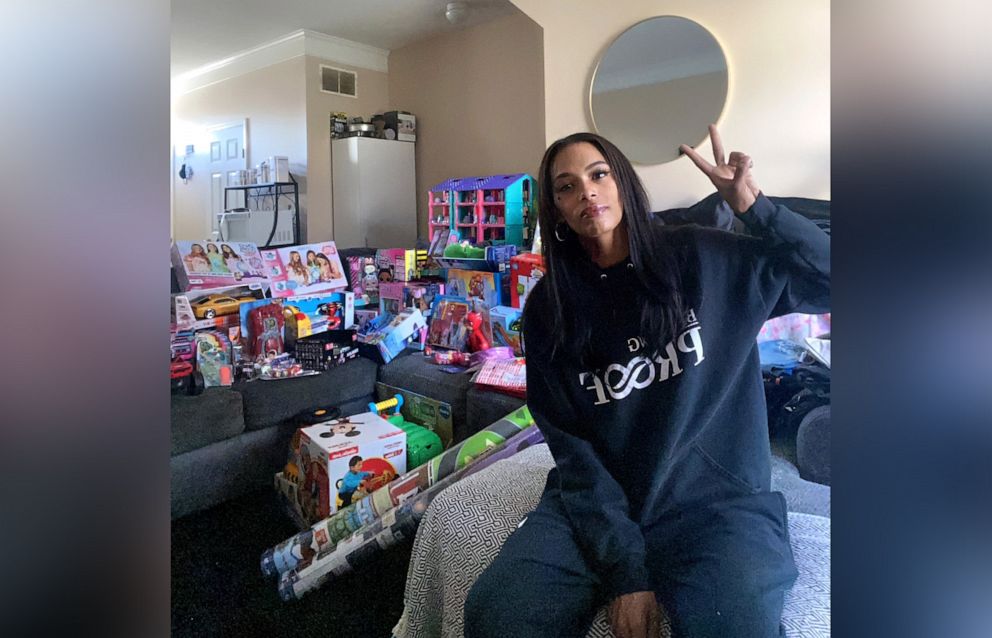 PHOTO: Janese Boston poses at her home with gifts for the children of the "Create a link" toy collection that she founded in Franklin County, Ohio.