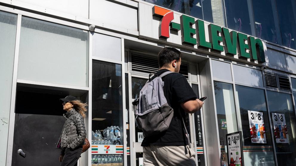 PHOTO: A person walks past a 7-Eleven convenience store in New York, Oct. 9, 2024. 