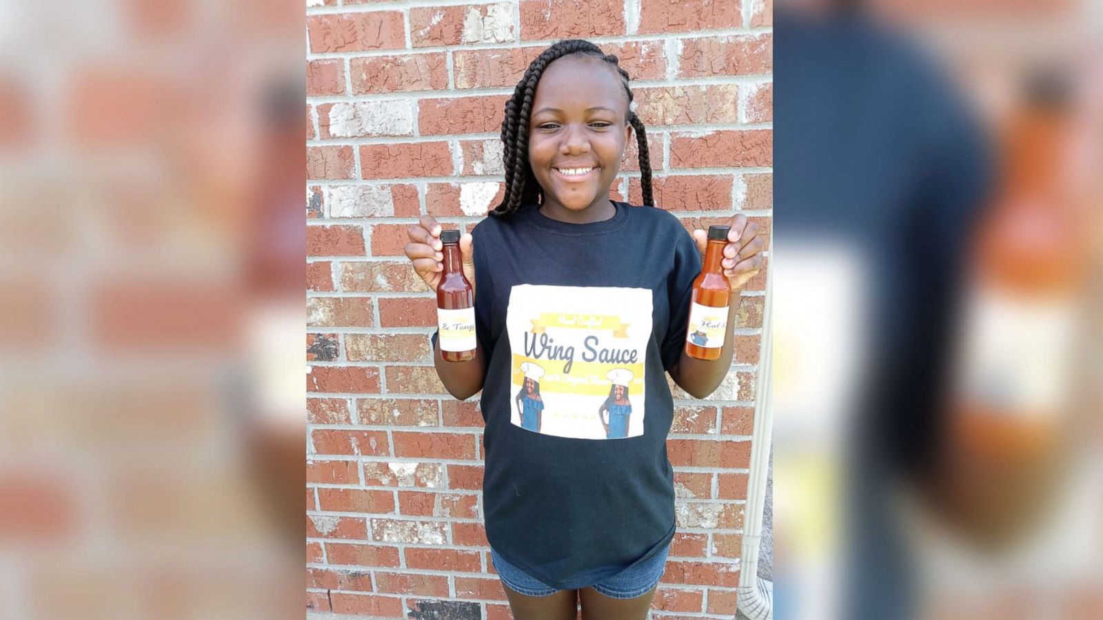 PHOTO: A'Jzala Johnson of Luling, Louisiana holds bottle of hot sauce she produced.