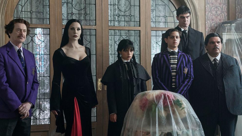 PHOTO: Wednesday. (L to R) Steve Buscemi as Barry Dort, Catherine Zeta-Jones as Morticia Addams, Jenna Ortega as Wednesday Addams, Isaac Ordonez as Pugsley Addams, Joonas Suotamo as Lurch, Luis Guzman as Gomez Addams in episode 201 of Wednesday. 