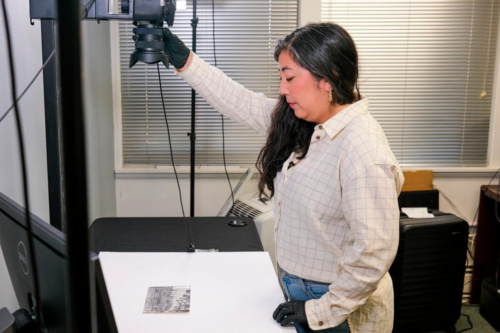 PHOTO: Caitlin Oiye Coon demonstrates one way that the archivists at Densho digitally preserve family artifacts and photographs for their digital repository.