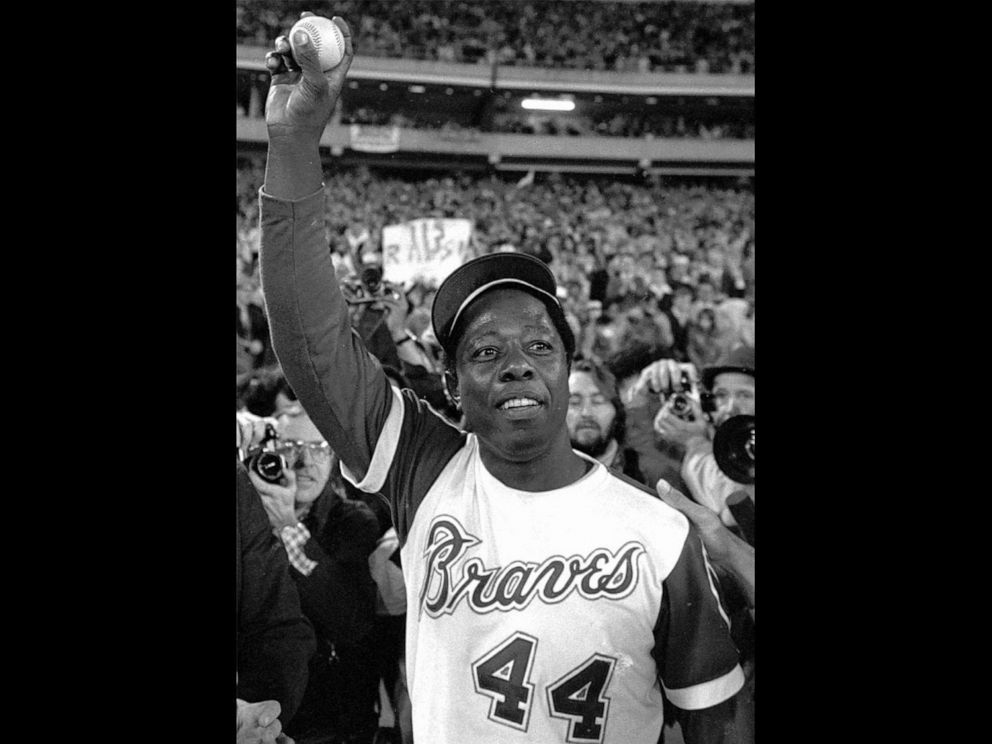 PHOTO: Hank Aaron holds the ball he hit for his 715th home run on April 8, 1974