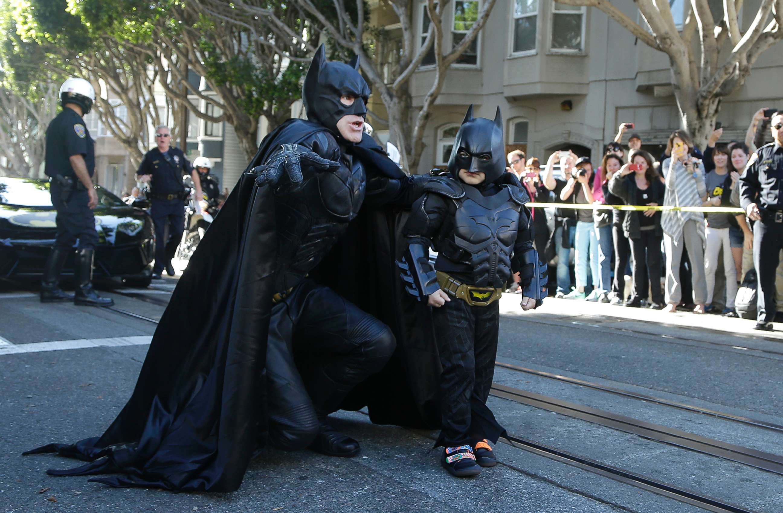 PHOTO: Miles Scott, dressed as Batkid, right, walks with Batman before saving a damsel in distress in San Francisco, Nov. 15, 2013. 