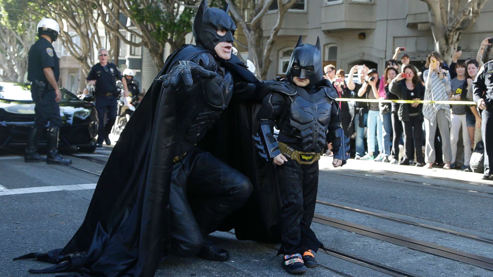 PHOTO: Miles Scott, dressed as Batkid, right, walks with Batman before saving a damsel in distress in San Francisco, Nov. 15, 2013.