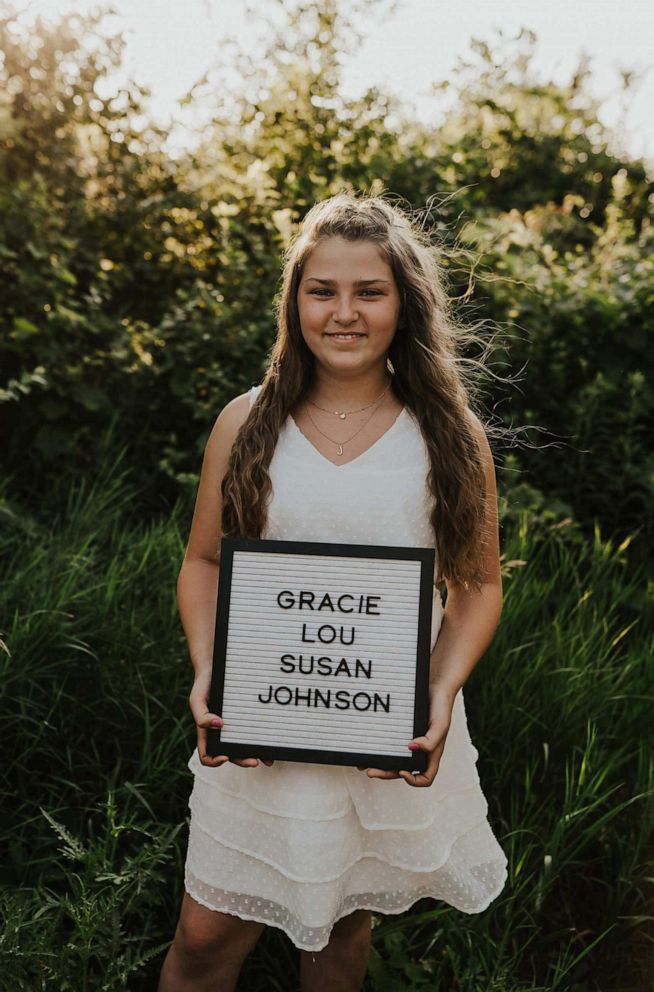 PHOTO: Gracie Johnson poses with a sign displaying her adopted name in July 2021.