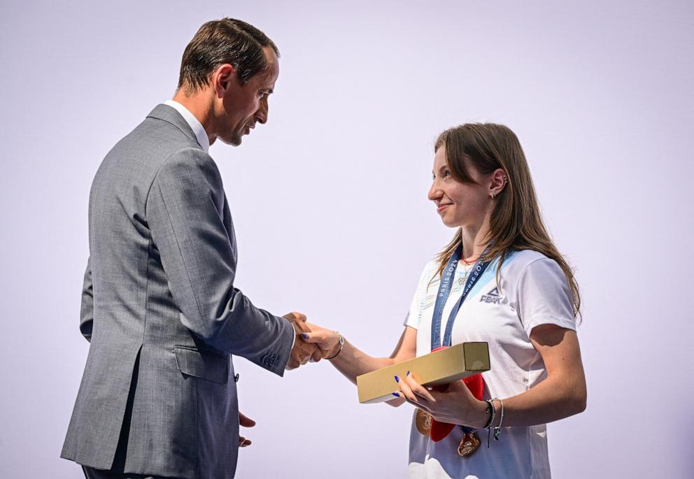 PHOTO: Romanian gymnast Ana Maria Barbosu is presented with an Olympic bronze medal by Mihai Covaliu, the president of Romanian Olympic Committee, Aug. 16, 2024, in Bucharest, Romania.