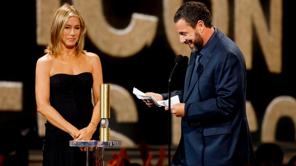 PHOTO: Jennifer Aniston presents Adam Sandler with the People's Icon Award during the 2024 People's Choice Awards in Santa Monica, CA, Feb. 18, 2024.